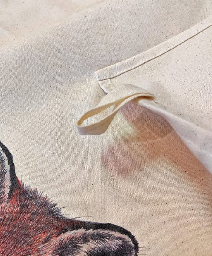 A3 tea towel featuring two foxes, designed exclusively for OneKind by artist Kate Louise Powell.